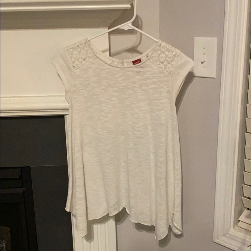 Sheer shirt with floral design on the shoulders.